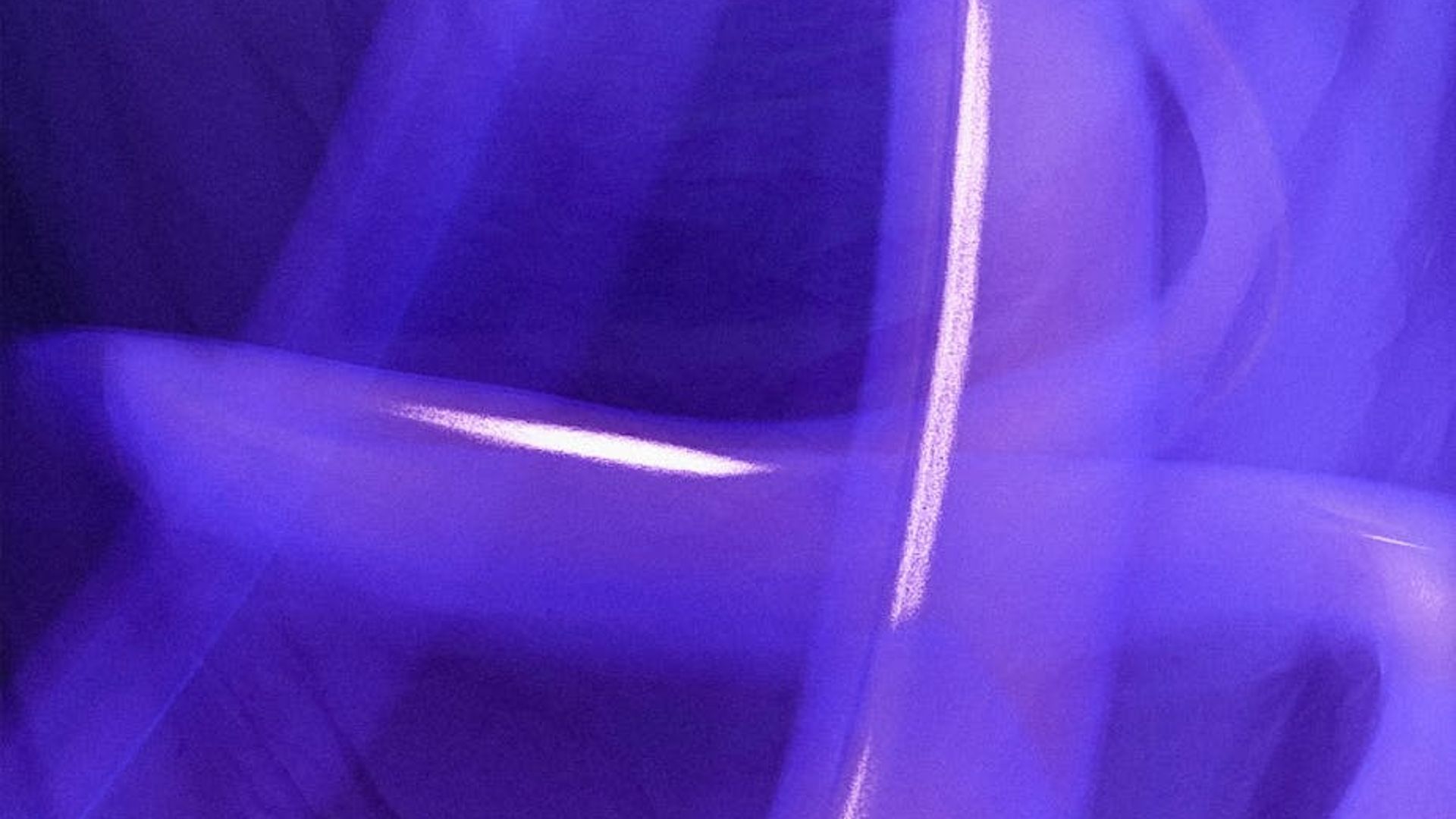 Abstract background with soft purple light trails suggesting focus and movement.